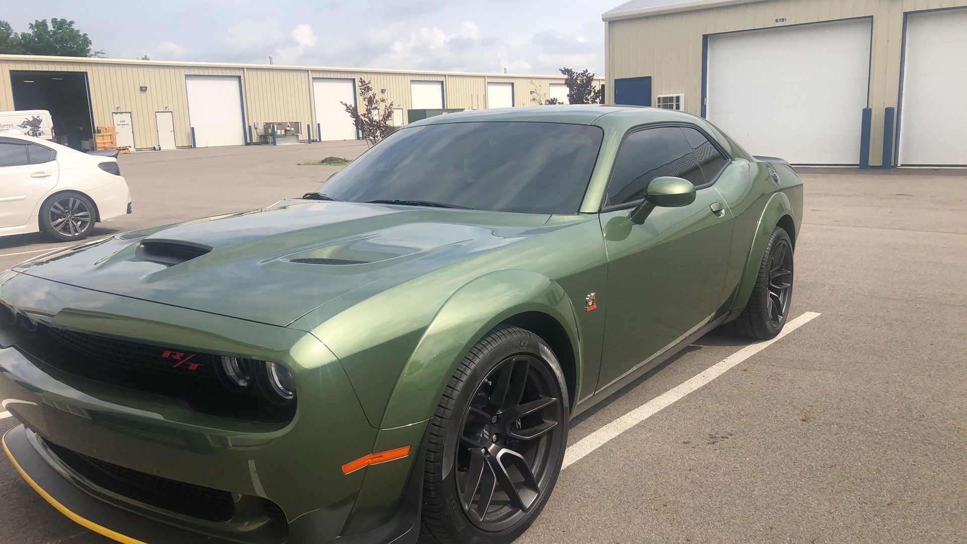 alt="Green Dodge Challenger with full front windshield tint for glare and UV protection"