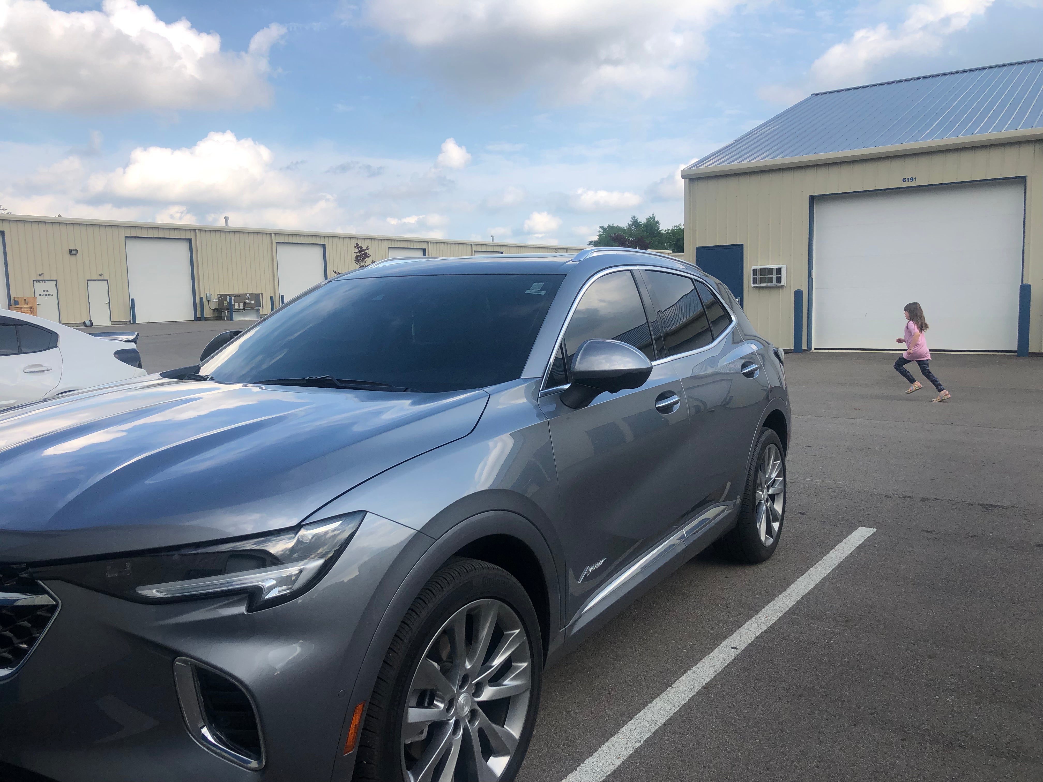 alt="Grey SUV with full front windshield tint for glare reduction and interior protection"