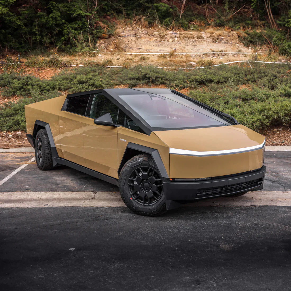 alt="Paint Protection Film applied to Tesla Cybertruck with desert tan wrap"