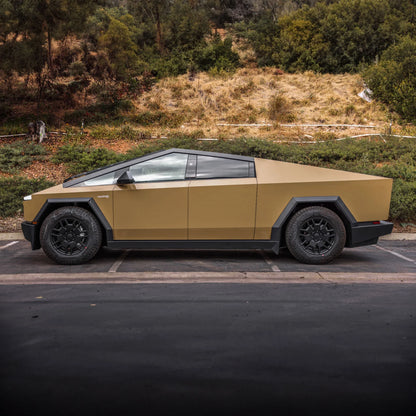 alt="Tesla Cybertruck wrapped in desert tan parked outdoors"