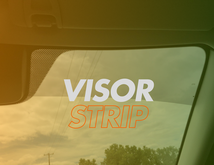 alt="Close-up of commercial visor strip tint installed on front windshield for glare reduction"